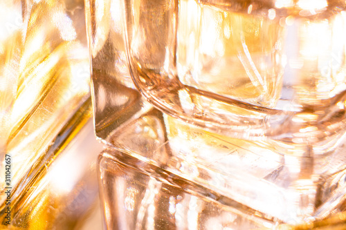 Beautiful bokeh and light reflections in yellow glass perfume bottles