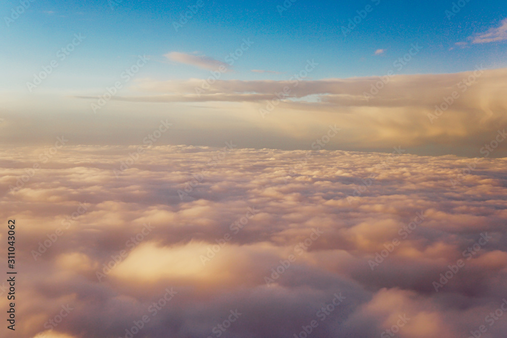Sky with clouds at sunset from inside the plane landscape