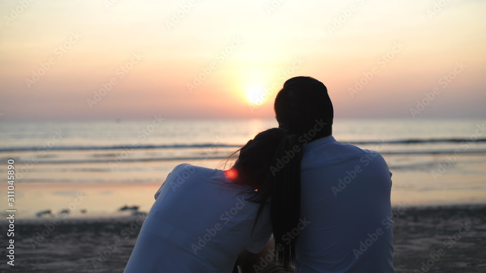 Holiday concept. Young lovers making heart-shaped hands on the beach. 4k Resolution.