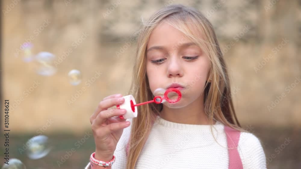Happy little girl playing outdoor, blowing soap bubbles, having fun on park . Happy little girl playing outdoor, blowing soap bubbles, having fun on park .