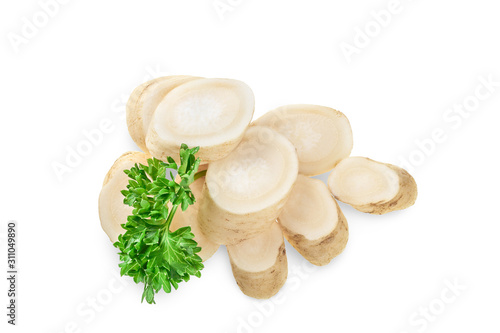 Horseradish root slices and parsley isolated on white background. Top view. Flat lay