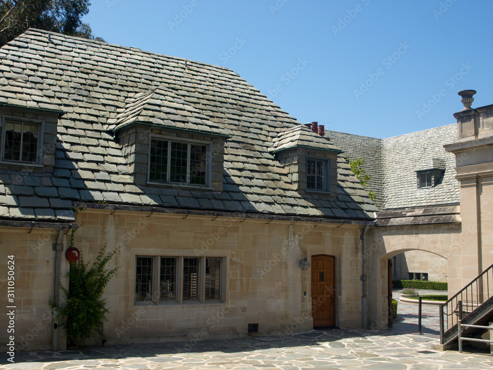 Slate tiled roof and a limestone house with a cobbled courtyard