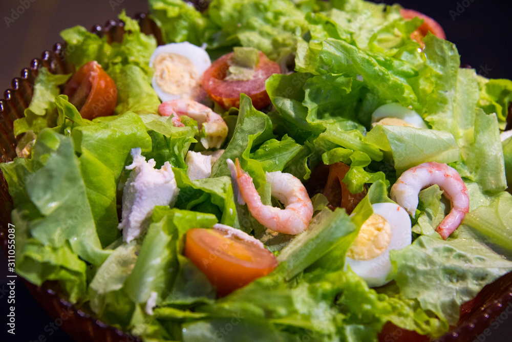 Tomatoes, shrimps, eggs and green salad. Closeup Tomatoes, shrimps, eggs and green salad. Closeup