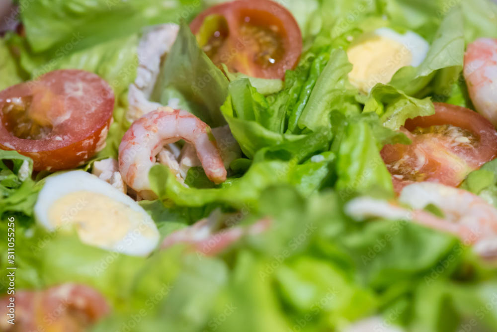 Tomatoes, shrimps, eggs and green salad. Closeup Tomatoes, shrimps, eggs and green salad. Closeup