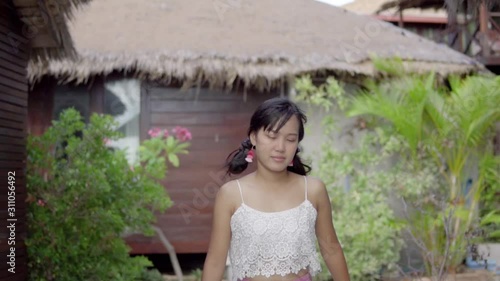 Young woman walking on the beach.
