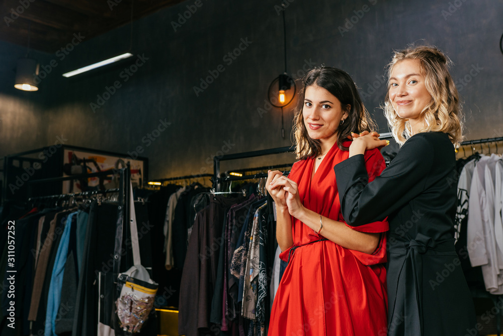 Blond trendy woman in black dress smelling a perfume tester in a shop. Blond trendy woman in black dress smelling a perfume tester in a shop.