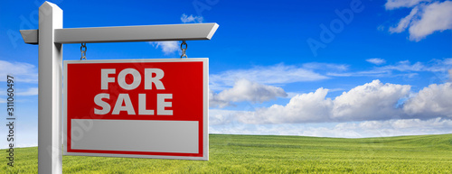 Fotografie Land for sale wooden placard in the countryside, green field landscape backgroun