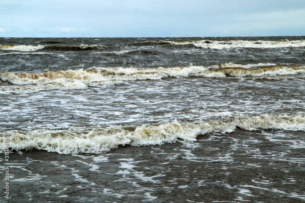 The baltic coast in Latvia during the rainy and windy day. The sea is wild and the waves are quite big. The beaches are empty. The baltic coast in Latvia during the rainy and windy day. The sea is wild and the waves are quite big. The beaches are empty.