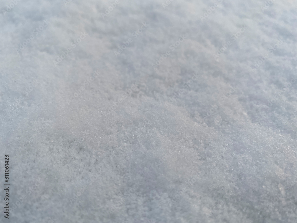 Obraz premium Closed up snowflakes on the ground in winter season. Beautiful contrast between white ice and brown land background.