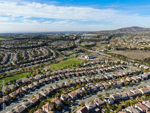 Aerial view of upper middle class neighborhood with identical residential subdivision houses during sunny day in Chula Vista  California  USA.