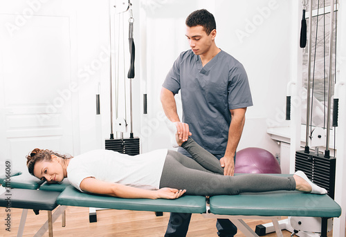 woman visiting her physiotherapist. Patient doing exercise for joint treatment