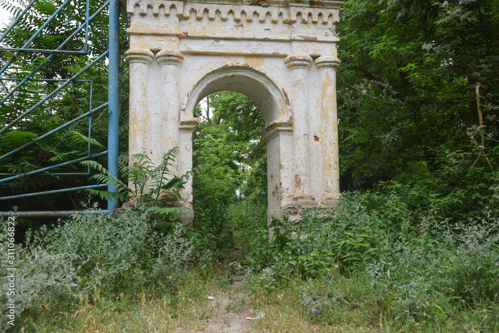 ancient abandoned arch in a dense forest of unknown people