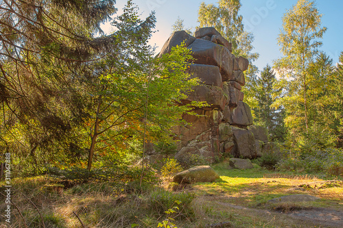 Felsenklippen auf einer Anhöhe im Harz mit Wald an einem Herbsttag photo