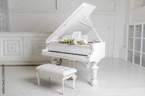 white piano in a white interior. Luxury interior.