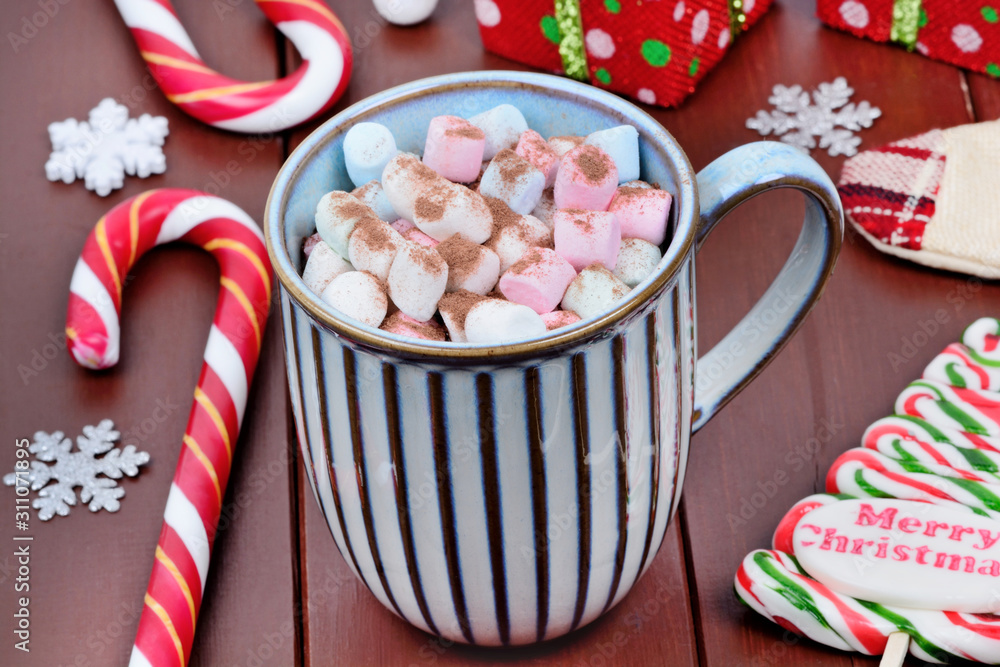 Hot chocolate in a mug with colorful marshmallow on a wooden table Hot chocolate in a mug with colorful marshmallow on a wooden table