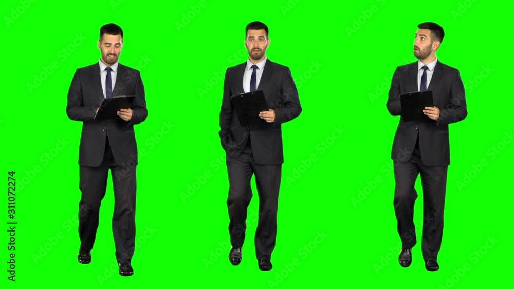 Businessman with a tablet walks on Green screen. Three takes. Businessman with a tablet walks on Green screen. Three takes.