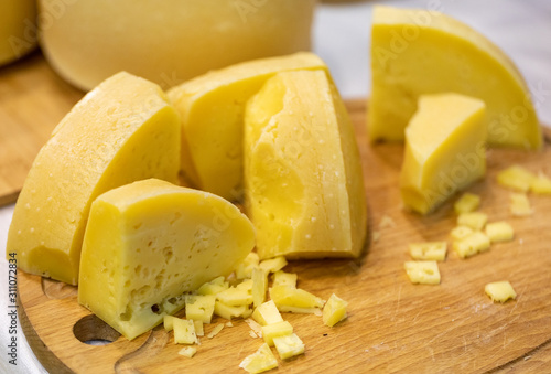 pieces of cheese on cutting board photo