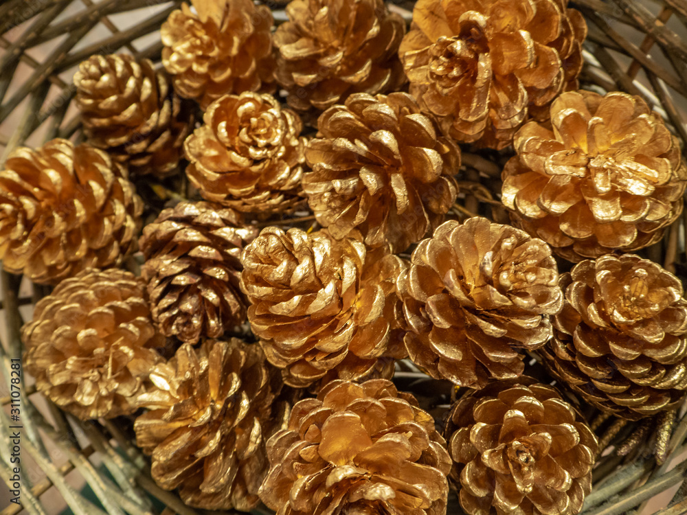 Golden cones in a wicker basket. Christmas and new year background and concept. Golden cones in a wicker basket. Christmas and new year background and concept.