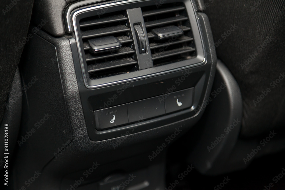 Control switch heated two rear seats on the car dashboard with plastic buttons to control the temperature of the passenger compartment and comfort while driving. Auto service industry.