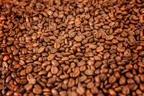 Coffee beans in a dense layer. Background. Space for text.