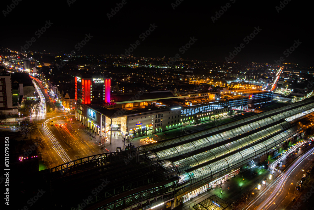 Aerial night view of a shopping mall and a railway station in Germany