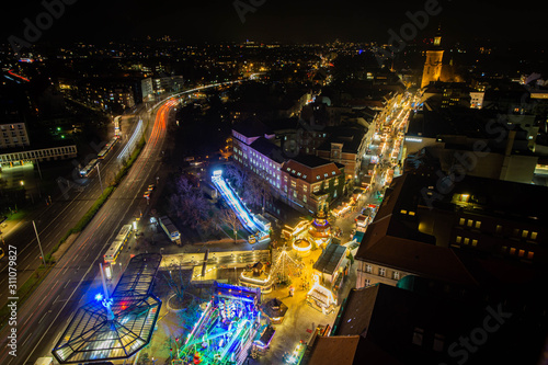 Aerial night view of a christmas market in germany, church in background