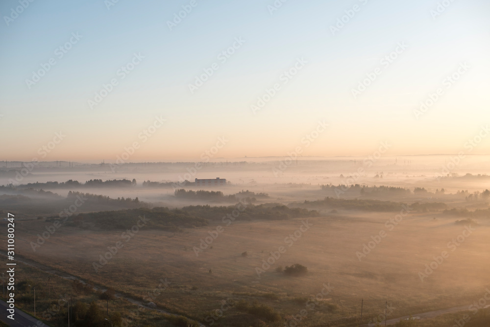 Fog over the fields, calm morning view. High-altitude photography.