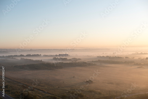 Fog over the fields, calm morning view. High-altitude photography.