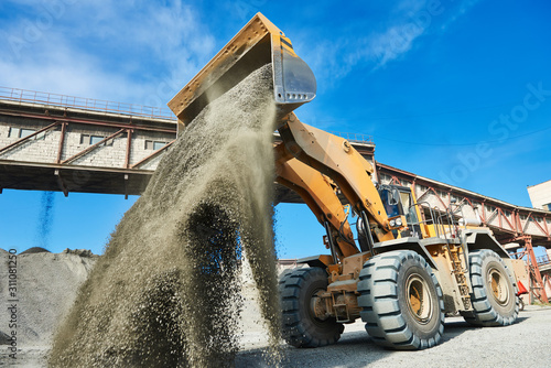 wheel loader loading granite or ore at sorting plant photo