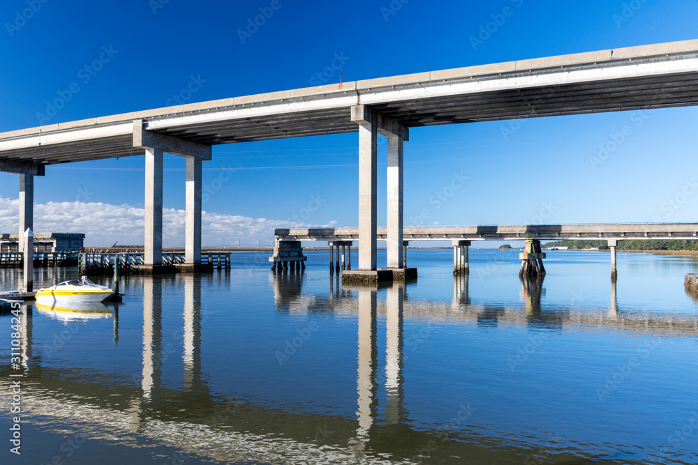 The calm waters and causeway bridge spanning Fancy Bluff Creek to Jekyll Island are seen from the marina. The Sidney Lanier Bridge into Brunswick is in the background.