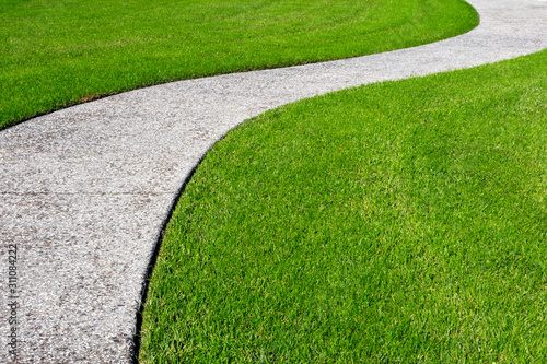 A thick carpet of zoysia grass and an oyster shell tabby pathway suggest the abstract concept of a journey, or of a beautifully maintained garden.