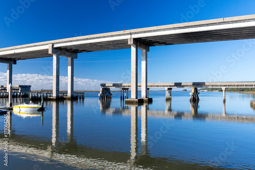 The calm waters and causeway bridge spanning Fancy Bluff Creek to Jekyll Island are seen from the marina. The Sidney Lanier Bridge into Brunswick is in the background. © Joanne Dale