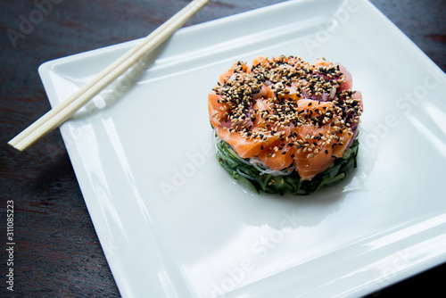 sunomonu in white dish hashi shoyo sauce raw salmon and sesame, asian food, japanese cuisine photo