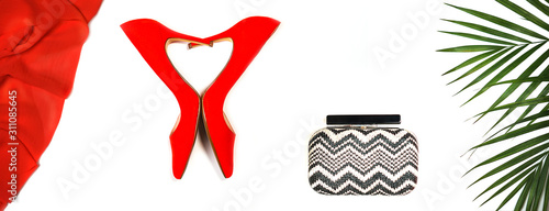 Red shoes  clutch  tropical leaves on white.