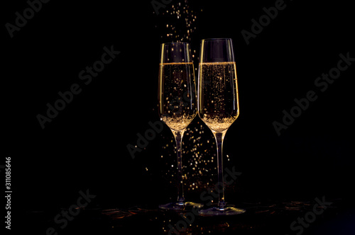 Glasses of champagne with black background and lights