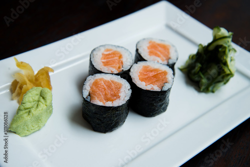 salmon hossomaki on a white plate, japanese traditional sushi, sushi photo