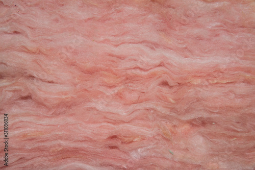 Closeup view of layers of pink fiberglass insulation.  photo