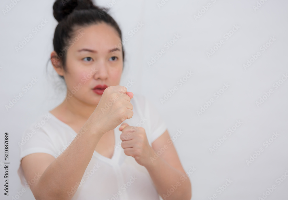 A picture of a woman raising a fist in her hand to show resistance and wanting to stop the violence in Concept Violence against women in a white background. A picture of a woman raising a fist in her hand to show resistance and wanting to stop the violence in Concept Violence against women in a white background.