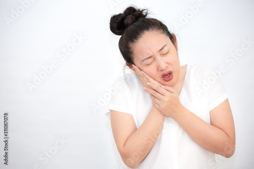 A picture of a woman with a toothache, putting a hand on her cheek, pain, having dental health problems and looking after the dentist.