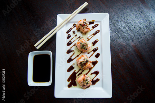 sushi on plate, sweet and sour sushi sauce, top view, wooden background,  asian food, japanese cuisine, top view photo