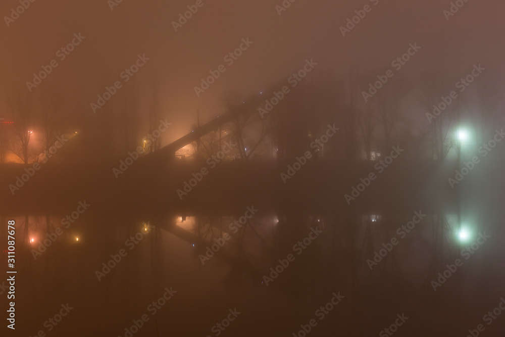 Fototapeta premium Thick Fog in the night Holesovice about River Vltava. Holesovice is the most cool Prague District, Czech Republic.