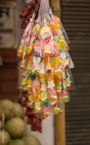 colorful packed marshmallow hanging in a local road side shop with a blurry background