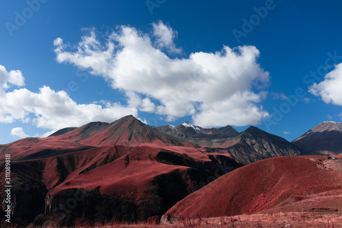 A panoramic view of Mount Kazbegi is a sleeping stratovolcano and one of the main mountains of the Caucasus, located on the border of the Kazbegi region of Georgia. In lush lava color. Design and crea