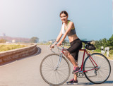 Beautiful Asian female exercise by bicycle