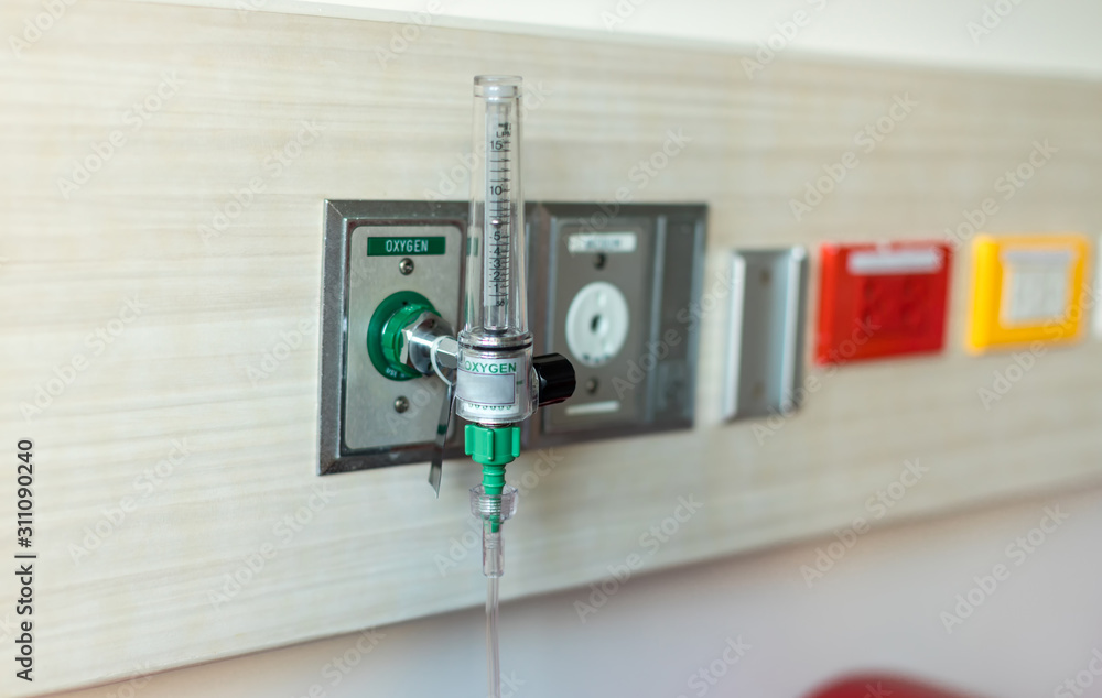 Oxygen flow meter plugged in the green outlet on hospital wall, Medical equipment. Oxygen for patients in the wall. Oxygen Gas Pipeline connection Inside Hospital ICU Room. Oxygen flow meter plugged in the green outlet on hospital wall, Medical equipment. Oxygen for patients in the wall. Oxygen Gas Pipeline connection Inside Hospital ICU Room.