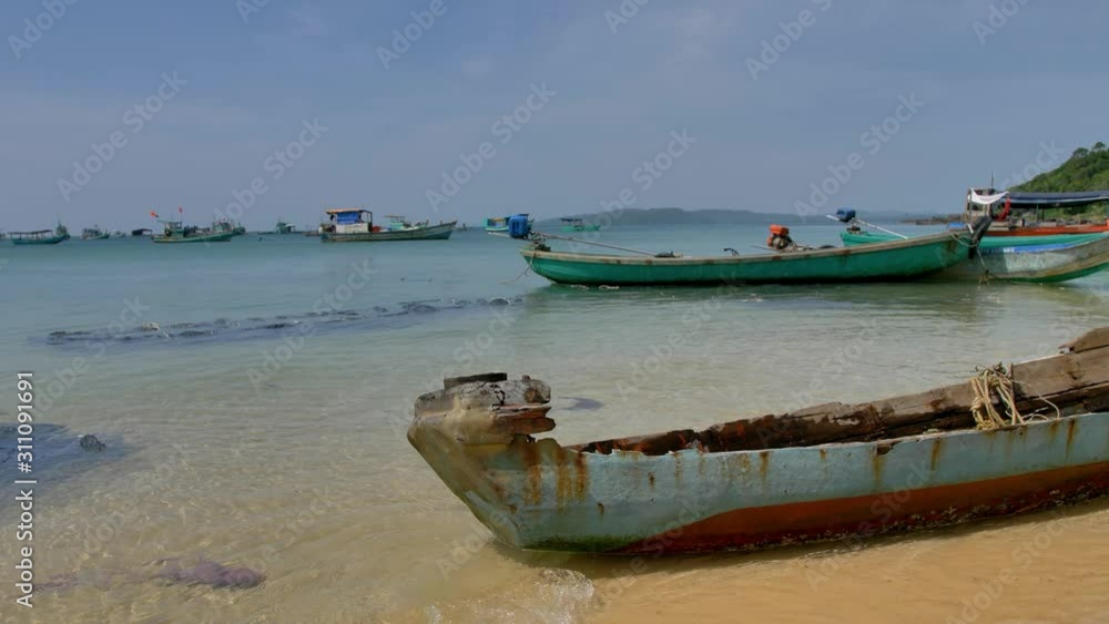 Phu Quoc island, Vietnam. Beautiful sun, traditional boats, people relaxing on the beach. Phu Quoc island, Vietnam. Beautiful sun, traditional boats, people relaxing on the beach.
