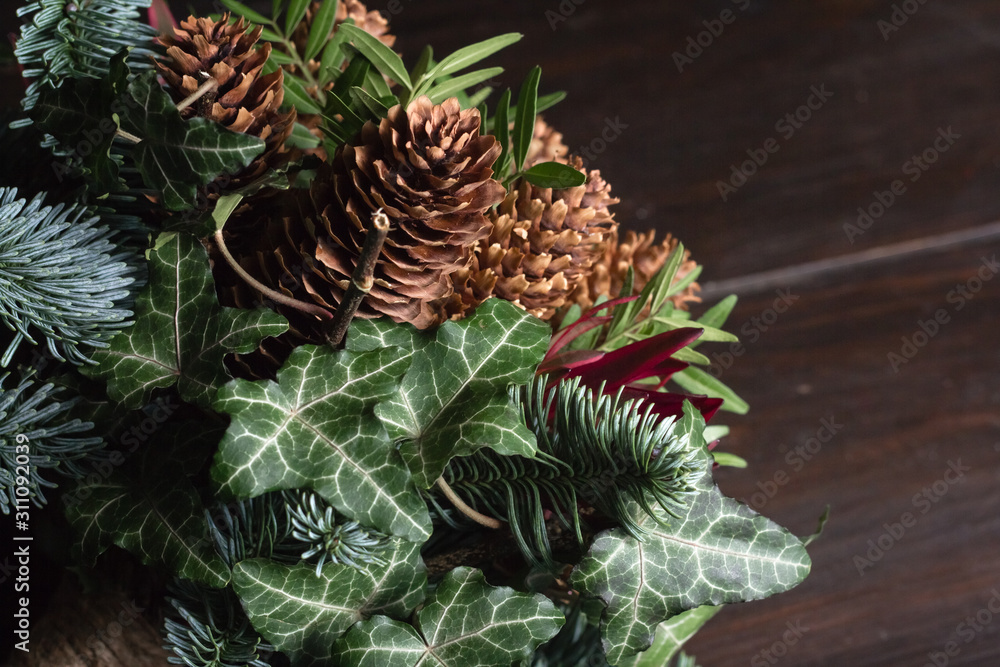 Winter bouquet of Nobil fir twigs, cones, pistachio, leucodendron and ivy, winter gift concept Winter bouquet of Nobil fir twigs, cones, pistachio, leucodendron and ivy, winter gift concept