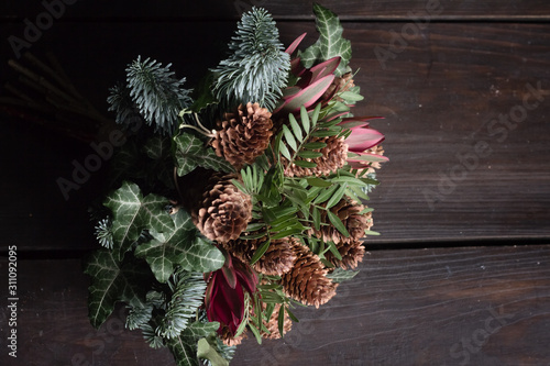 Winter bouquet of Nobil fir twigs, cones, pistachio, leucodendron and ivy, winter gift concept photo