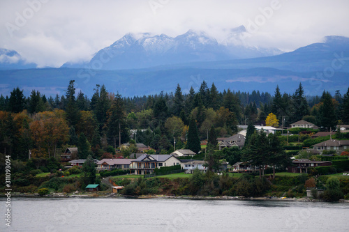Campbell River, Vancouver Island, British Columbia, Canada. Beautiful view of residential homes on the ocean shore during a cloudy evening. © edb3_16