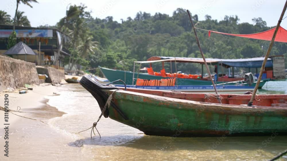 Phu Quoc island, Vietnam. Beautiful sun, traditional boats, people relaxing on the beach. Phu Quoc island, Vietnam. Beautiful sun, traditional boats, people relaxing on the beach.